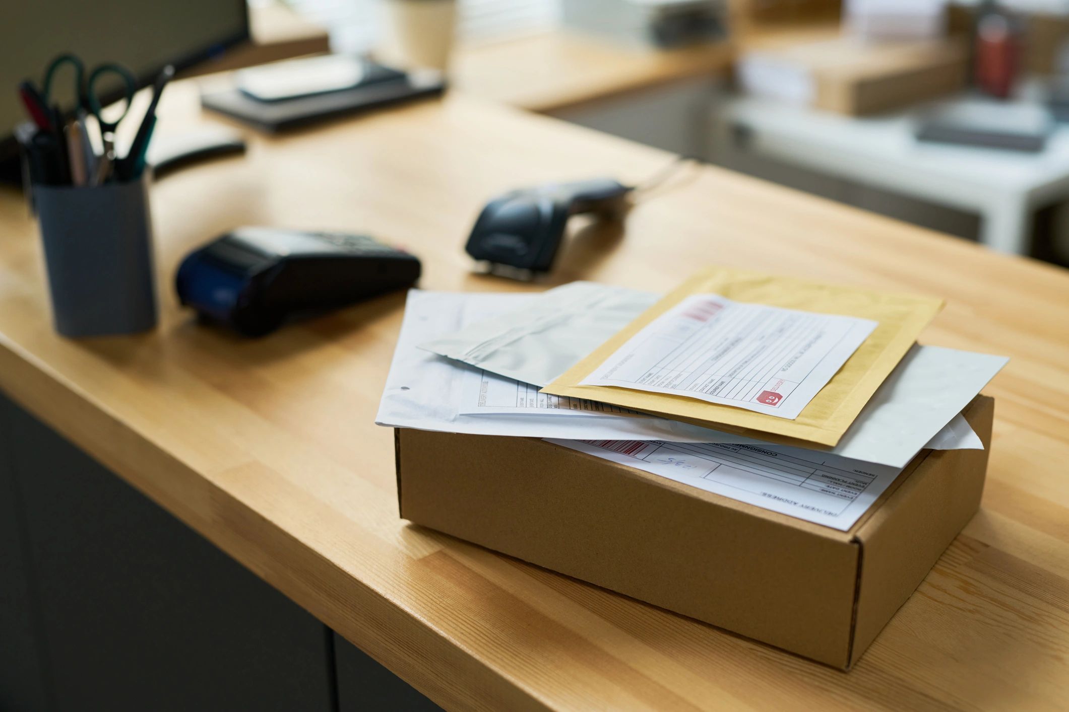 Shipping paperwork and parcels on a desk