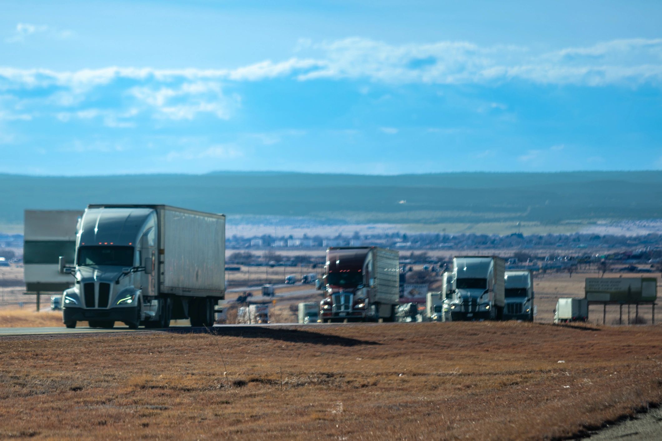 Commercial trucks lined up on open terrain representing launch readiness